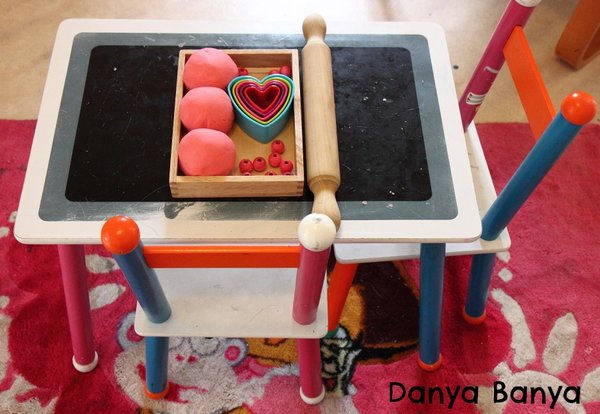 An invitation to play with play dough heart cookie cutters and beads