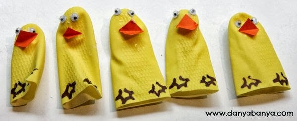 Making duckling finger puppets from the fingers of a rubber glove