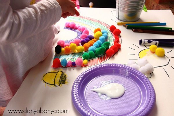 Pasting pom poms onto a rainbow - colour matching and fine motor skill practice for toddlers and preschoolers