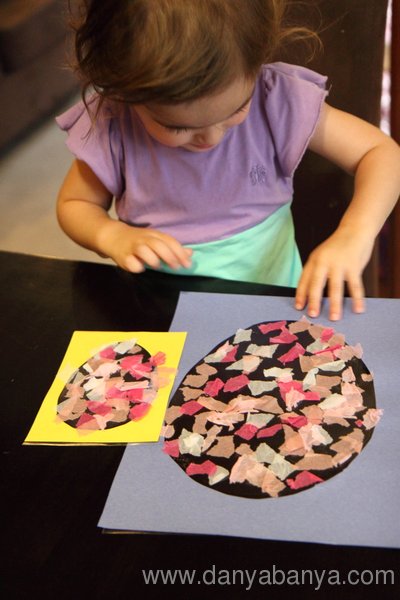 Toddler making Stained Glass Easter Egg with ripped up tissue paper