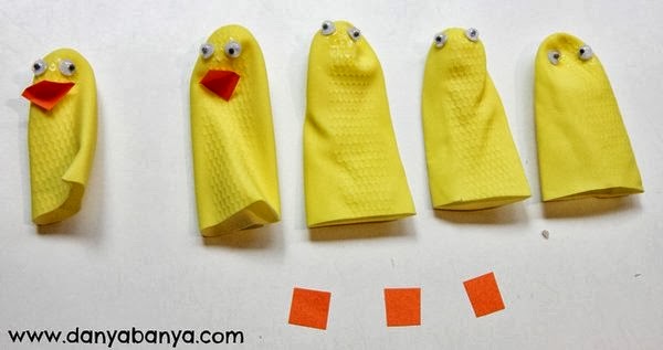 Making duckling finger puppets from the fingers of a rubber glove