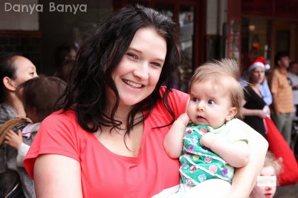 Danya Banya holding 3 month old baby Bee wearing Christmas onesie