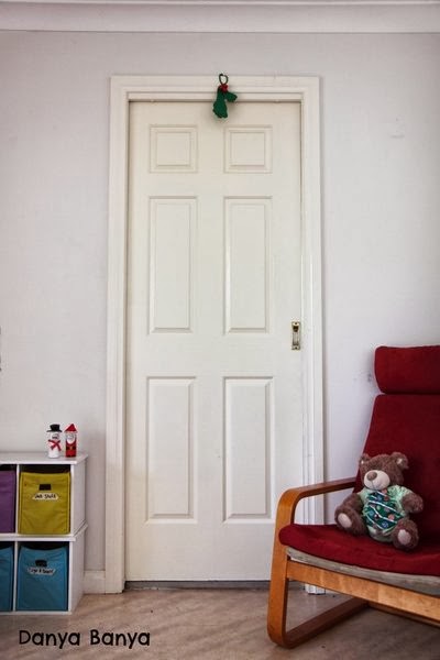 DIY kids footprint mistletoe hanging above door